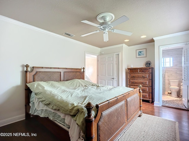 bedroom with a textured ceiling, dark wood-style flooring, visible vents, baseboards, and crown molding