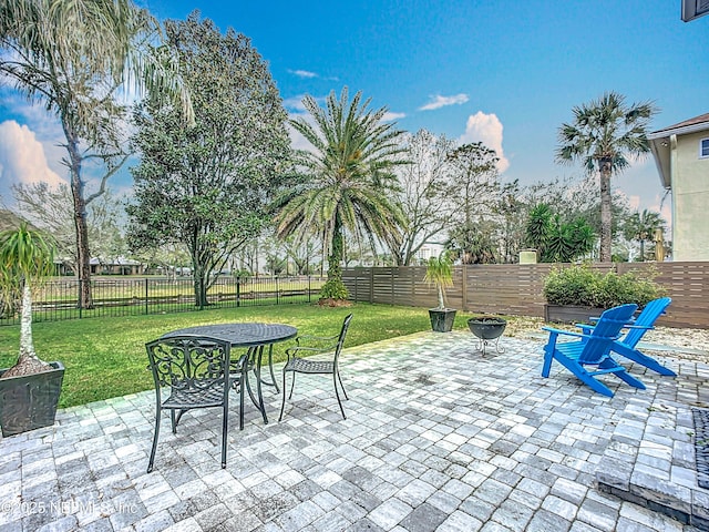 view of patio / terrace with an outdoor fire pit and a fenced backyard