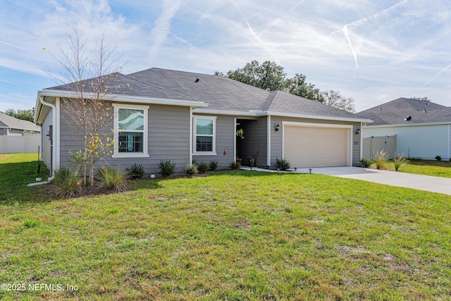 ranch-style home with a garage, fence, and a front yard