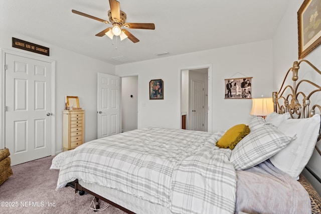 carpeted bedroom featuring ceiling fan and visible vents