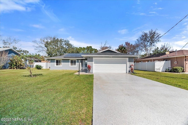 ranch-style house featuring solar panels, a front lawn, concrete driveway, and fence