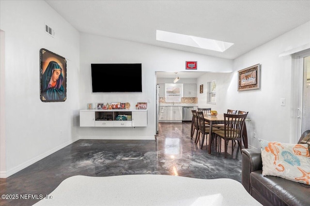 living room with vaulted ceiling with skylight, a healthy amount of sunlight, visible vents, and baseboards