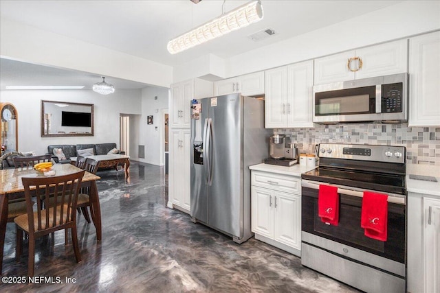 kitchen featuring stainless steel appliances, light countertops, backsplash, and visible vents