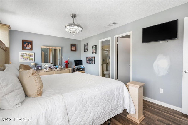 bedroom with baseboards, a textured ceiling, visible vents, and wood finished floors