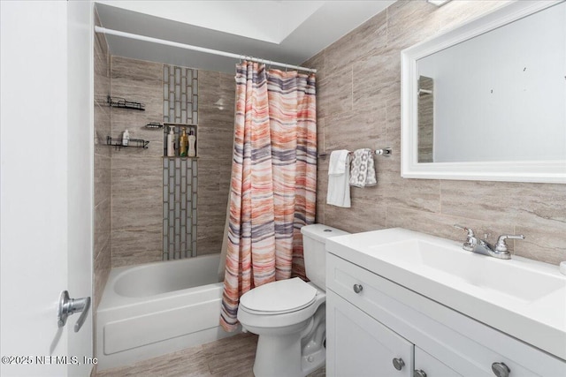 full bathroom with toilet, shower / tub combo, tile walls, and vanity