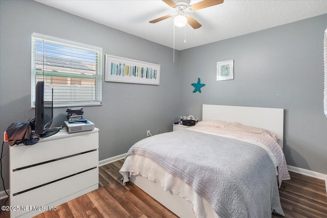 bedroom featuring a ceiling fan, a textured ceiling, baseboards, and wood finished floors