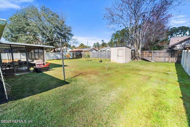 view of yard featuring a shed, an outdoor structure, and a fenced backyard