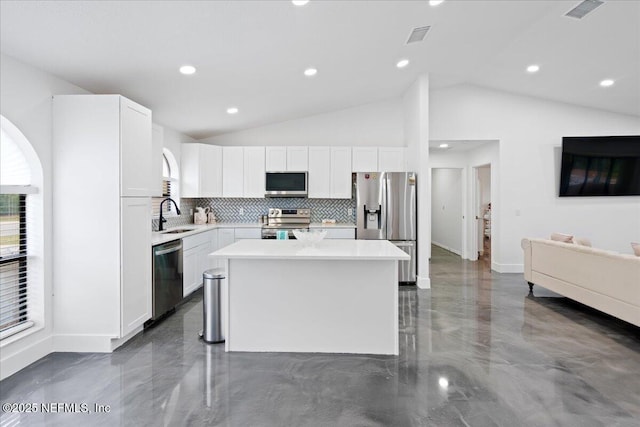 kitchen featuring a kitchen island, a sink, visible vents, white cabinetry, and appliances with stainless steel finishes