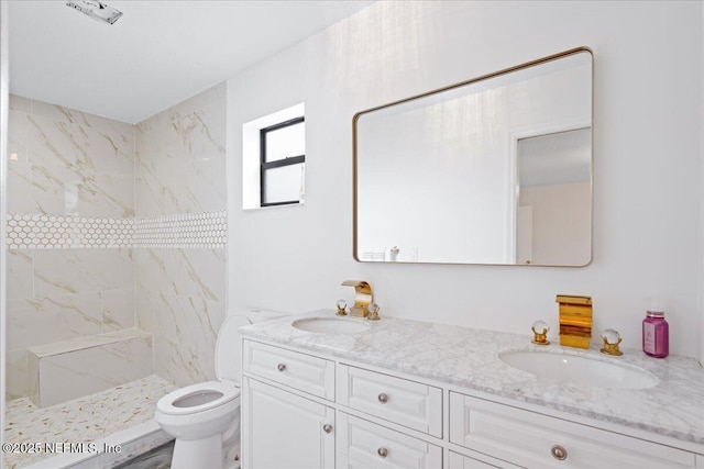 bathroom featuring tiled shower, a sink, toilet, and double vanity