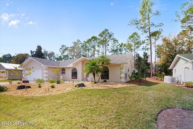 ranch-style home featuring an attached garage, a front yard, and stucco siding