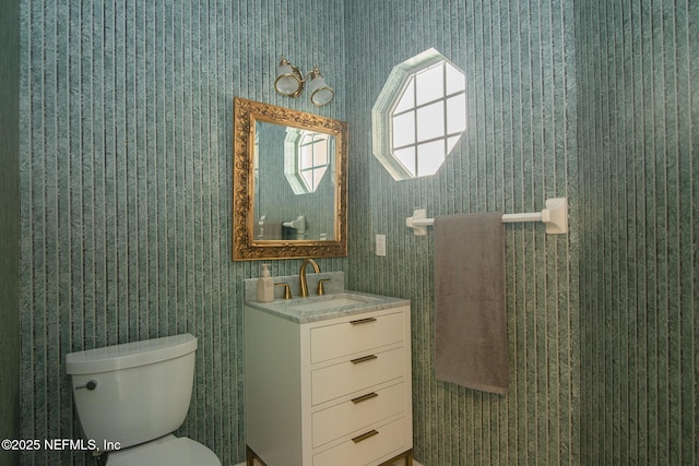 bathroom featuring toilet and vanity