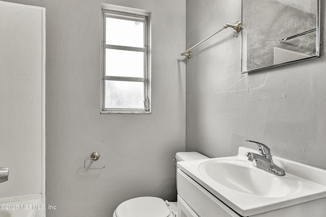 bathroom featuring toilet and vanity