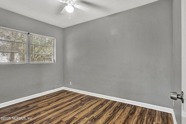 unfurnished room featuring a ceiling fan, dark wood-style flooring, and baseboards