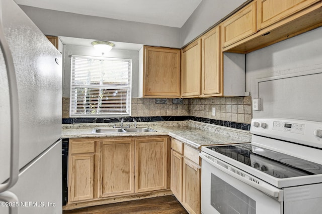 kitchen featuring white appliances, backsplash, a sink, and light countertops