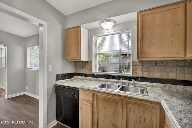 kitchen with tasteful backsplash, baseboards, dishwasher, light countertops, and a sink