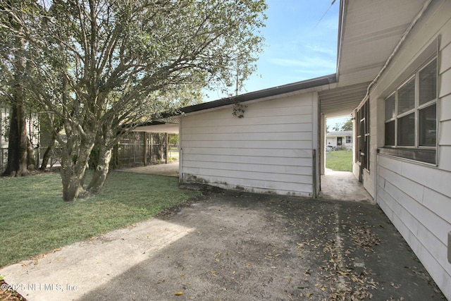 view of side of home with a lawn