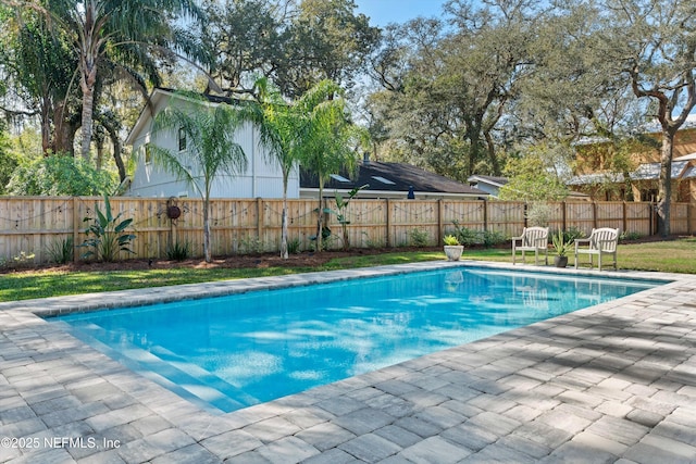 view of swimming pool with a fenced backyard, a fenced in pool, and a patio