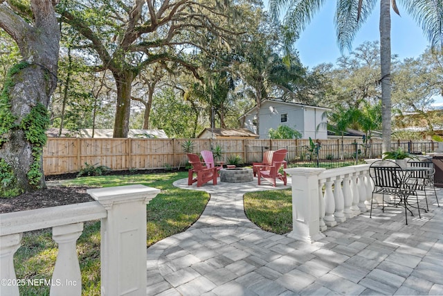 view of yard with an outdoor fire pit, a patio area, and fence