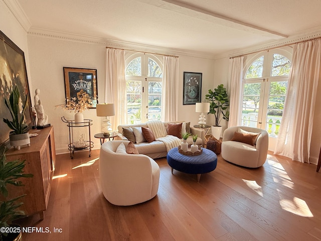 sitting room with crown molding and wood finished floors