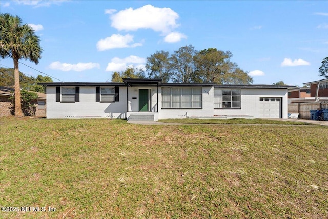 single story home with a garage, a front yard, and brick siding