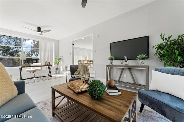 living room with ceiling fan and wood finished floors