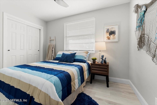 bedroom featuring a closet, ceiling fan, baseboards, and wood finished floors