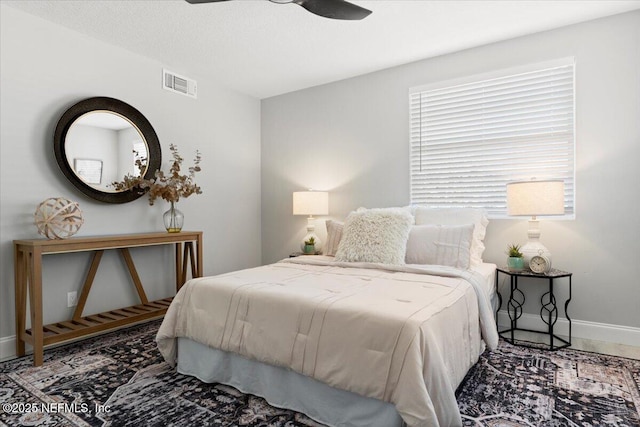 bedroom featuring baseboards, visible vents, ceiling fan, and a textured ceiling