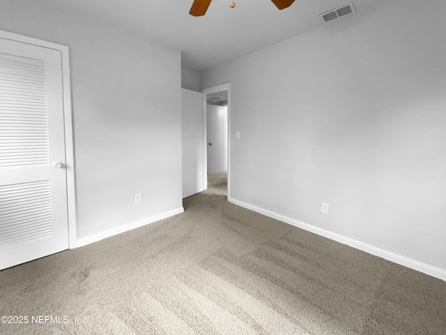 unfurnished bedroom with a ceiling fan, carpet flooring, visible vents, and baseboards