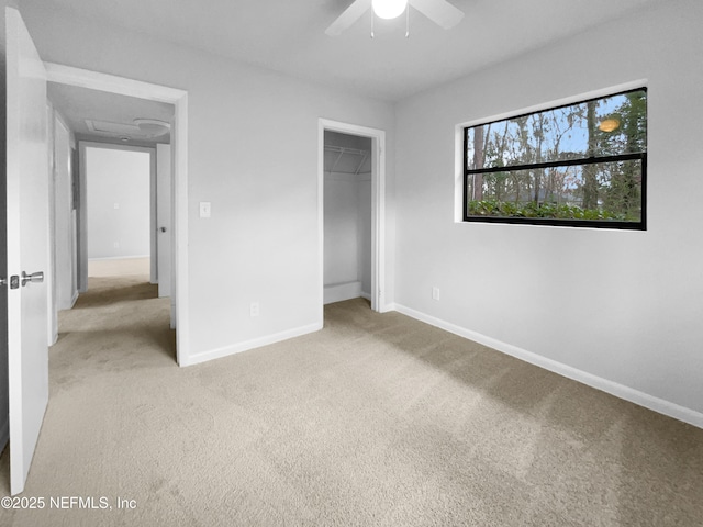 unfurnished bedroom featuring a closet, carpet, a ceiling fan, and baseboards