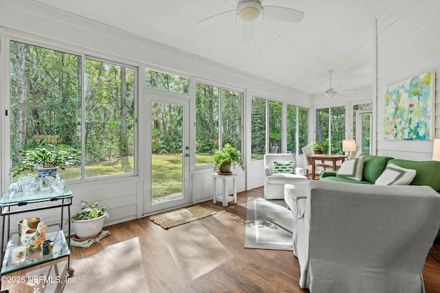 sunroom with lofted ceiling and ceiling fan