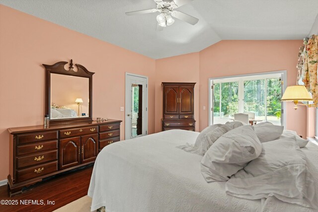 bedroom with vaulted ceiling, access to outside, ceiling fan, and dark wood-style floors