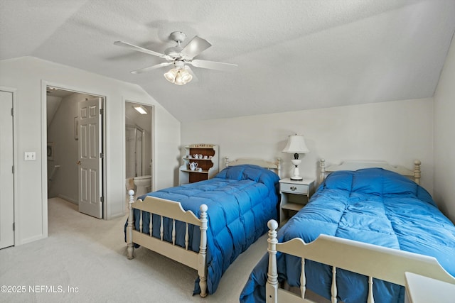 bedroom featuring carpet flooring, connected bathroom, vaulted ceiling, a textured ceiling, and ceiling fan