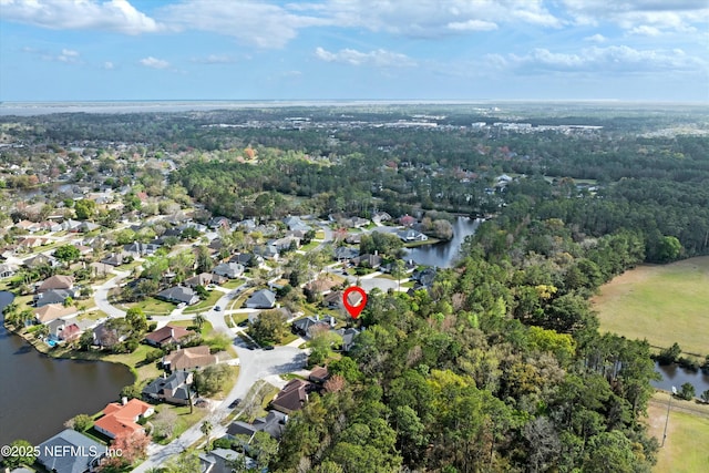 drone / aerial view featuring a residential view and a water view