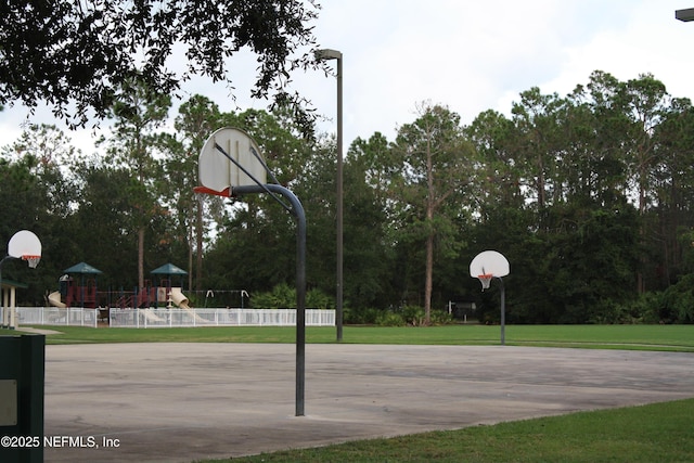 view of basketball court with community basketball court, a yard, playground community, and fence