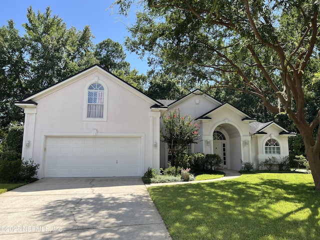 view of front of home with concrete driveway, a front lawn, and stucco siding