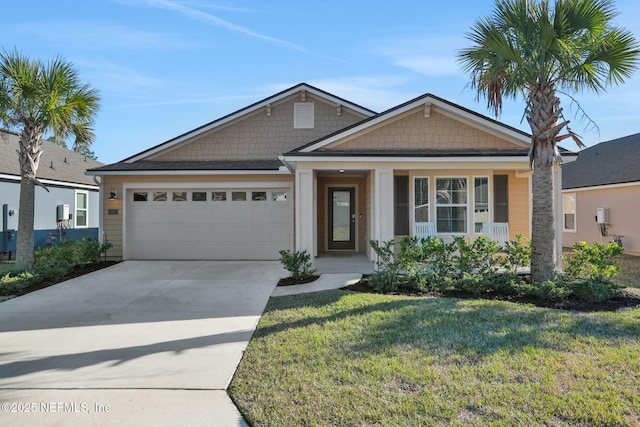 view of front of property featuring a front yard, concrete driveway, and an attached garage