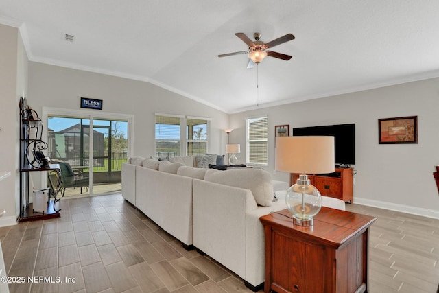 living room with baseboards, lofted ceiling, ceiling fan, wood finished floors, and crown molding