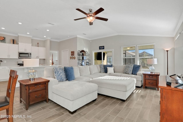 living area featuring wood finish floors, crown molding, lofted ceiling, visible vents, and ceiling fan