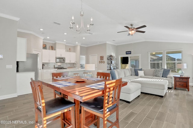 dining room featuring wood tiled floor, visible vents, vaulted ceiling, and baseboards