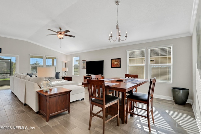 dining room with lofted ceiling, ceiling fan with notable chandelier, baseboards, wood tiled floor, and crown molding