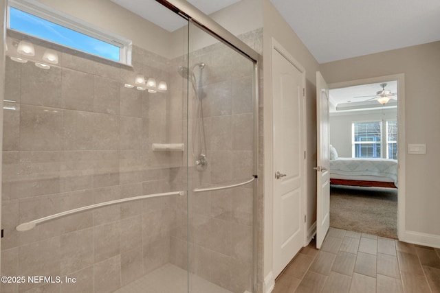 full bath featuring a stall shower, baseboards, and ensuite bathroom