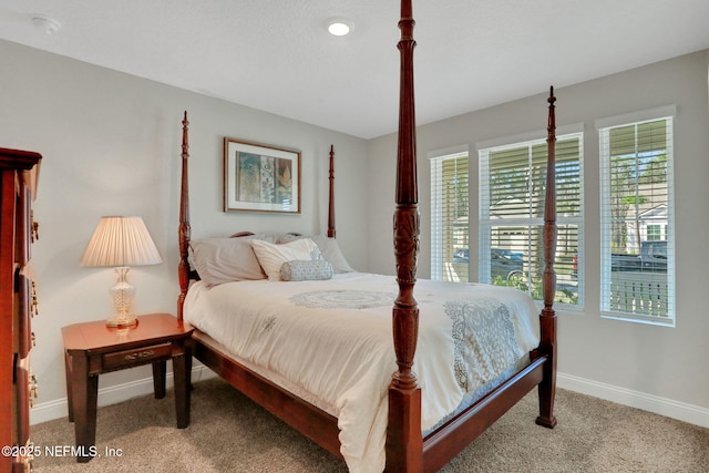 bedroom with carpet floors and baseboards