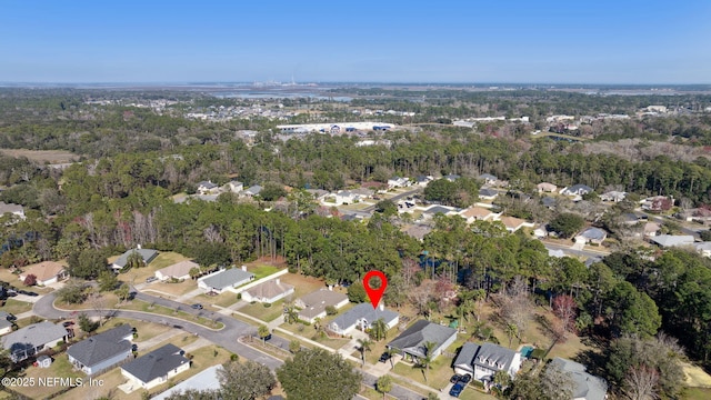 drone / aerial view with a residential view and a wooded view