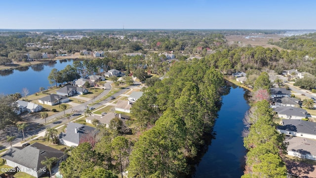 drone / aerial view featuring a water view and a residential view