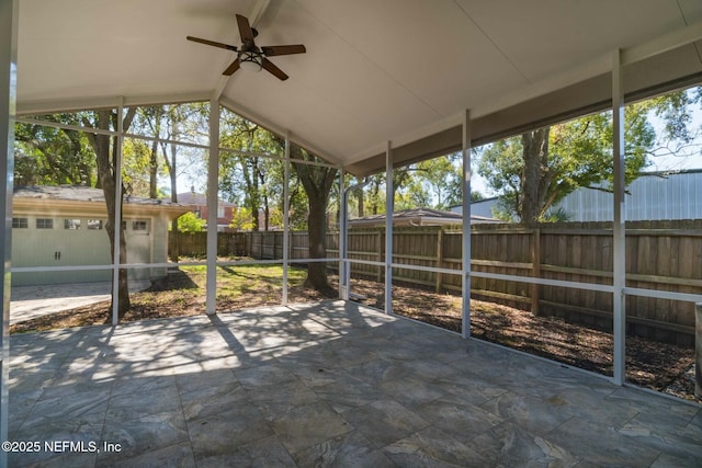 unfurnished sunroom featuring vaulted ceiling with beams and a ceiling fan