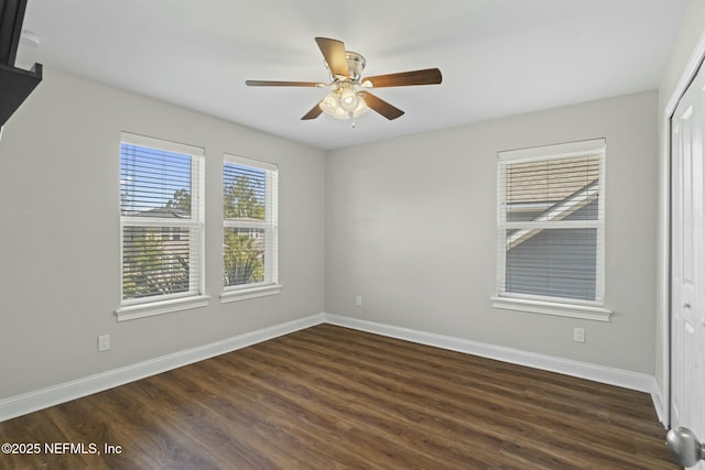 unfurnished bedroom featuring dark wood-style floors, a closet, ceiling fan, and baseboards