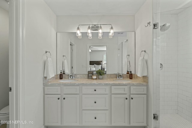 full bathroom with double vanity, a stall shower, and a sink