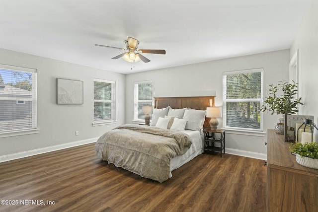 bedroom featuring dark wood-style floors, multiple windows, ceiling fan, and baseboards