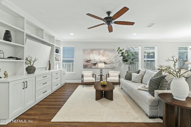 sitting room with dark wood-style floors, recessed lighting, visible vents, and crown molding