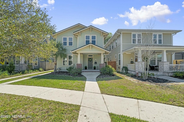 view of front of house featuring covered porch and a front lawn